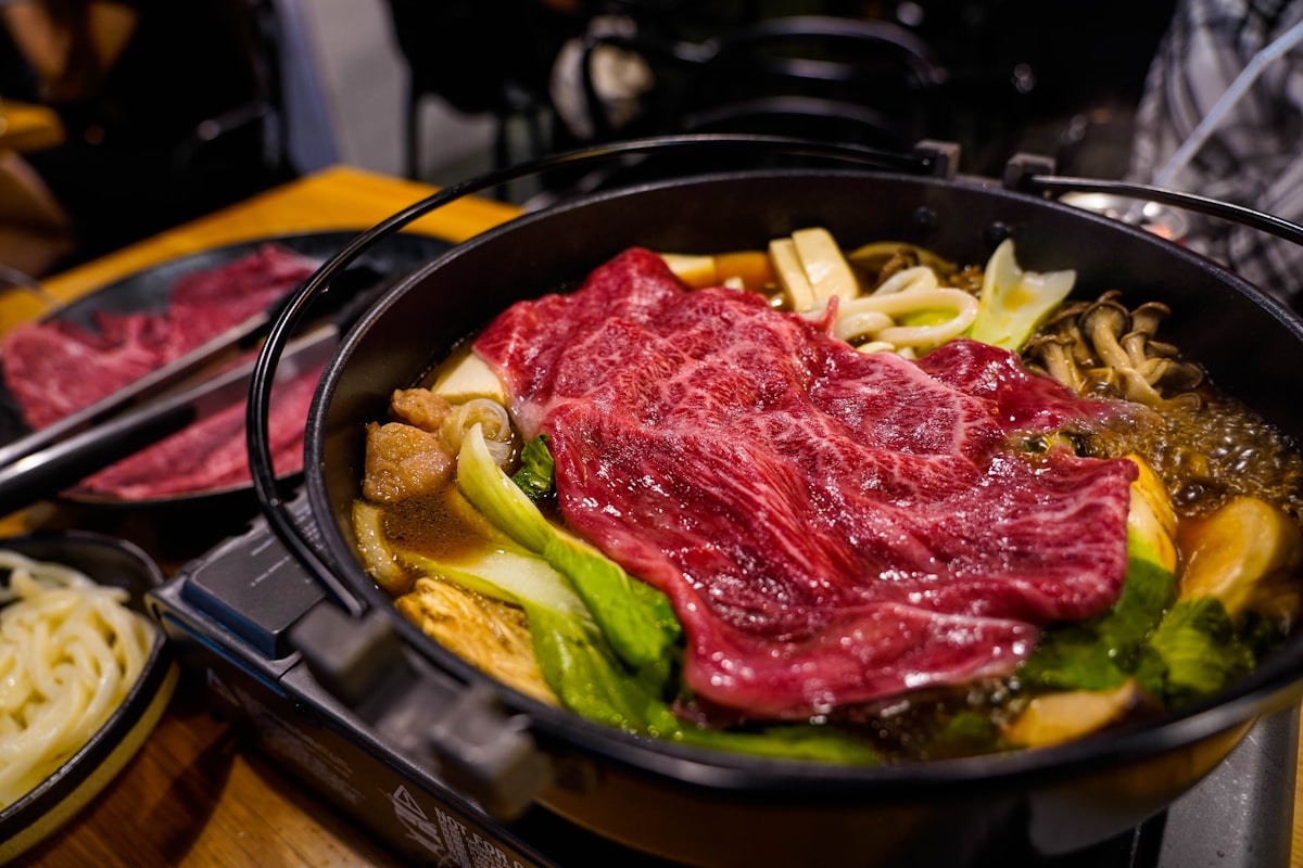 A pot of food with meat and vegetables in it
