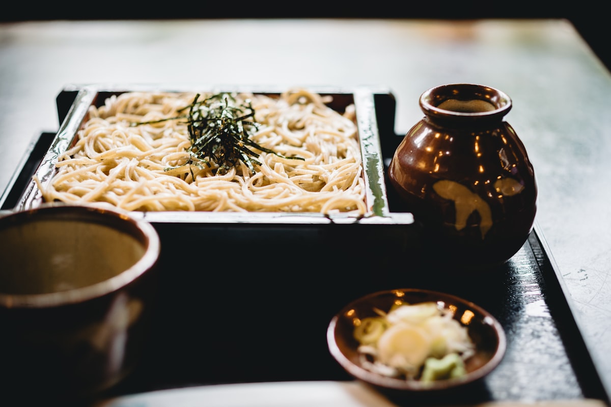 White pasta on black wooden plate