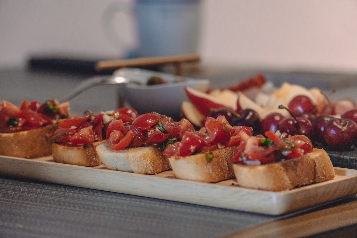 Sliced strawberries on bread on white ceramic plate