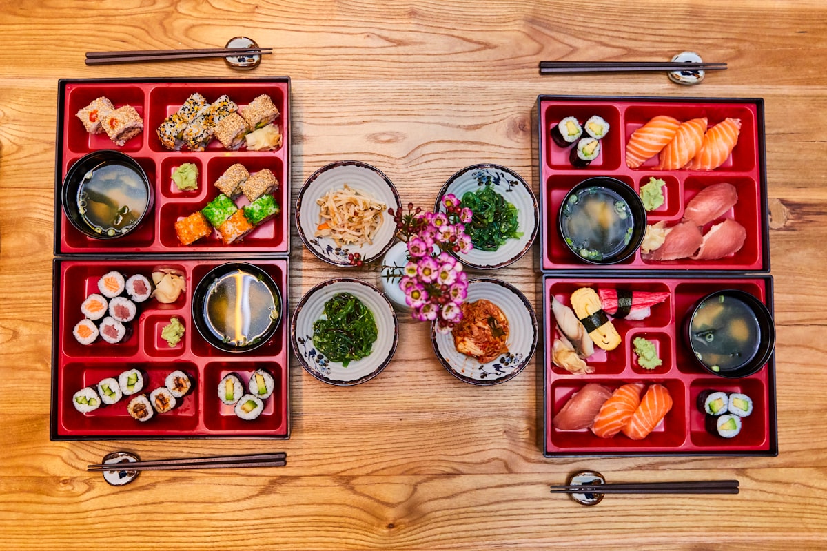 Red and green ceramic bowls on brown wooden tray
