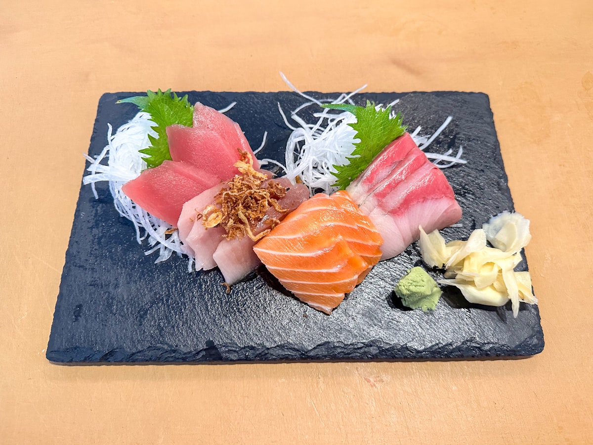 A plate of sushi on a wooden table